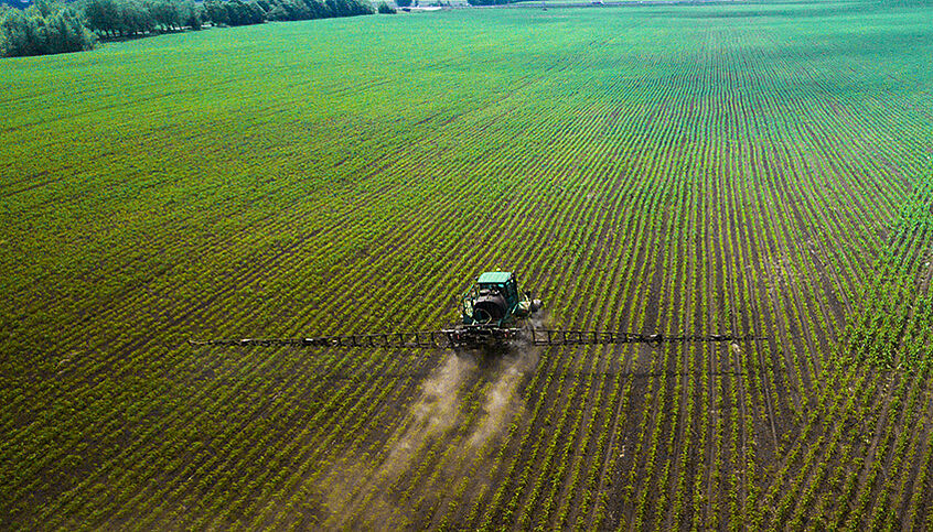 Tractor fertilises field