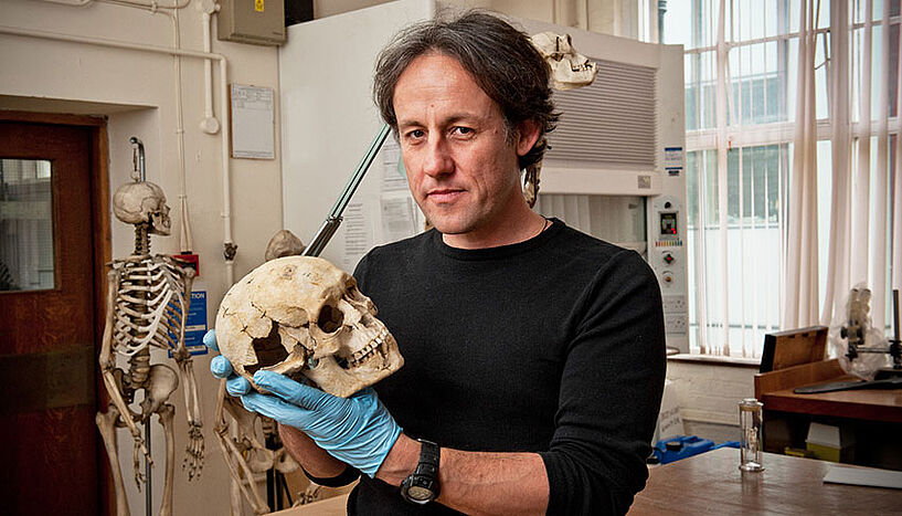 Tom Higham with a skull in his hands